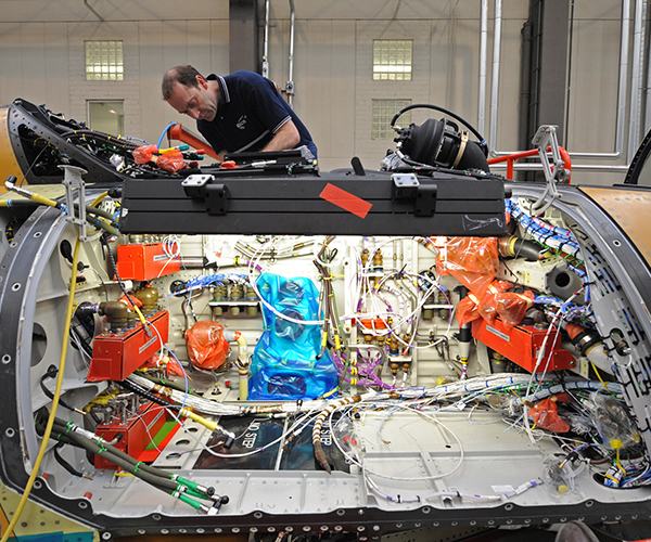 Aircraft maintainer routing Gore’s cables. 